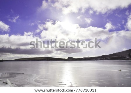 Frozen ice lake in winter with beautiful sky background and line pass on lake for sport