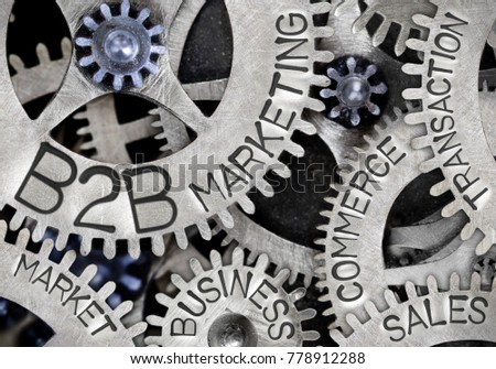 Macro photo of tooth wheel mechanism with B2B MARKETING concept related words imprinted on metal surface