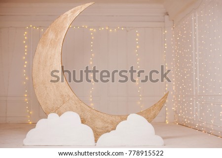 Beautiful Interior with a large Golden Moon in the Center of the Room and the twinkling lights of the garland           