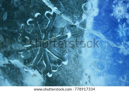 Blue snowflakes from ice. Cold background. Frozen pattern. Decorative decoration. Real photo. Raster image.