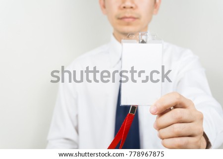 Man holding Identification white blank plastic id card.