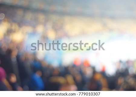 Blur image of cheers in the stadium with bokeh for background usage.