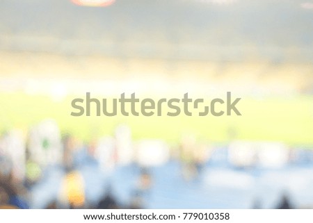 Blur image of cheers in the stadium with bokeh for background usage.