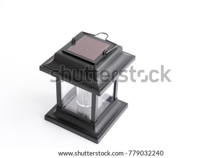 Garden lantern on solar panels in black, photographed on a white background in the studio.
