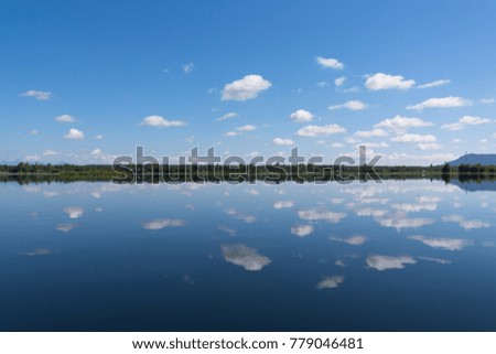 Beautiful Clouds reflect shadows in the lake.Bueng Kan Province of Thailand