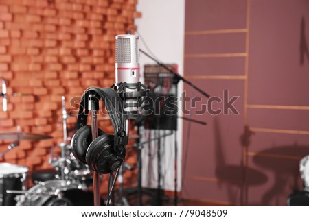 View of microphone with headphones in radio station