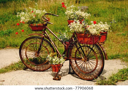 An old bicycle with flower baskets for decorating parks and gardens.