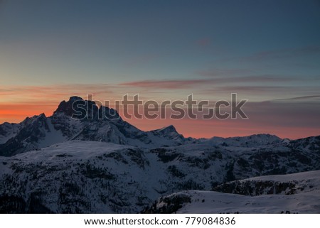 Aerial view of vivid beautiful sunset over winter alpine landscape