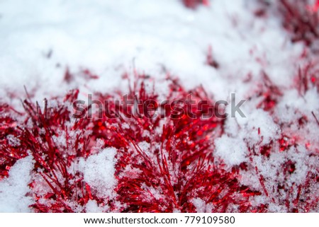 red garland covered with snow, christmas background