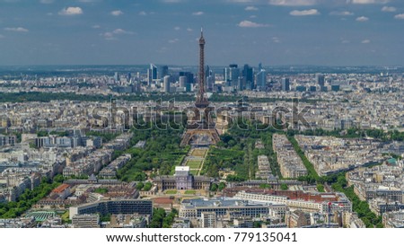 Aerial view from Montparnasse tower with Eiffel tower and La Defense district on background timelapse in Paris, France. Top view from observation deck at sunny summer day.