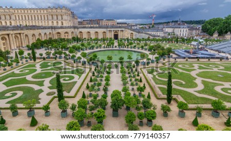Famous palace Versailles with beautiful gardens and fountains from top. The Palace Versailles was a royal chateau. It was added to the UNESCO list of World Heritage Sites. Paris, France. Royalty-Free Stock Photo #779140357