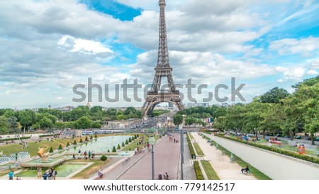 Fountains on famous square Trocadero with Eiffel tower in the background. Trocadero and Eiffel tower are the most visited attractions of Paris. Blue cloudy sky at summer day