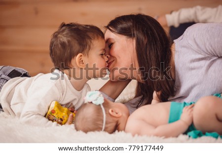 The mother with children lie on the bed