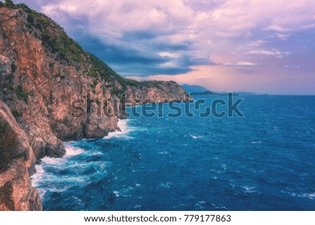 Amazing sunset seascape during a storm, wild mediterranean sea coast with waves breaking against rocks, Dubrovnik, Croatia