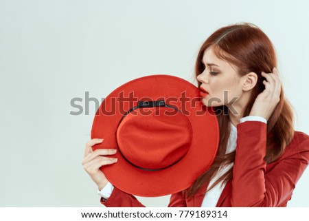  attractive, beautiful woman with a red hat on a light background, studio, beauty, style                              