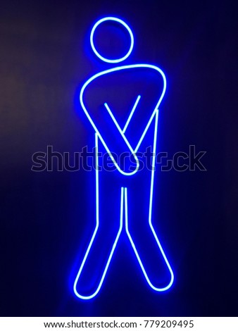 Blue neon light of men toilet symbol shape on dark blue wall