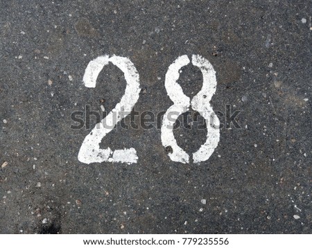 A figure of twenty-eight, depicted on the asphalt.