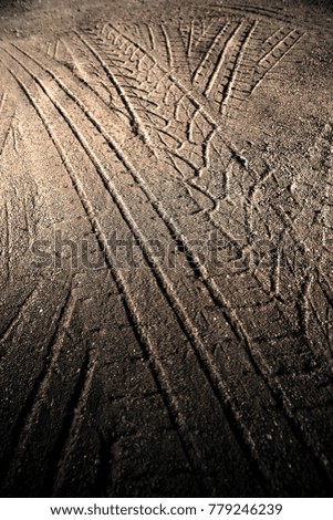 

Tyre track on dirt sand or mud, retro tone, grunge tone, drive on sand, off road track