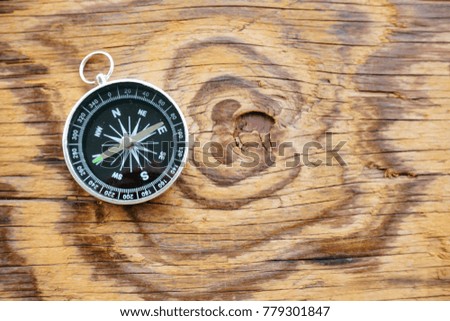 A compass on a wooden background.