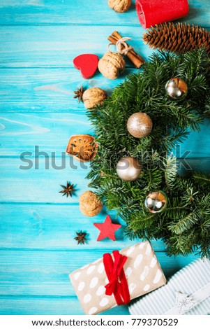 Christmas wreath and Christmas gifts on a blue wooden surface - view from above.