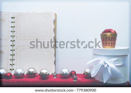 New Year and Christmas decoration wiht big vintage album and white round box 