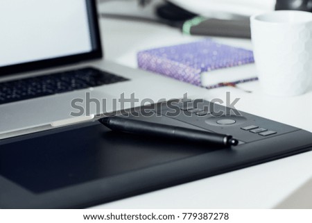 Workspace of professional retoucher. laptop, stylus and tablet for retouching. Workspace of professional retoucher.