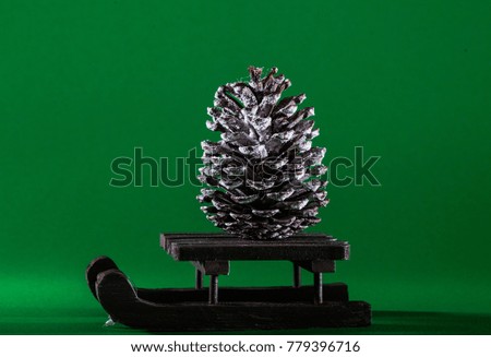 Santa Claus sleighs on the winter road. Christmas - New Year concept. Forest made of pine cones and flour. Flat lay. Aerial photography. Green Background