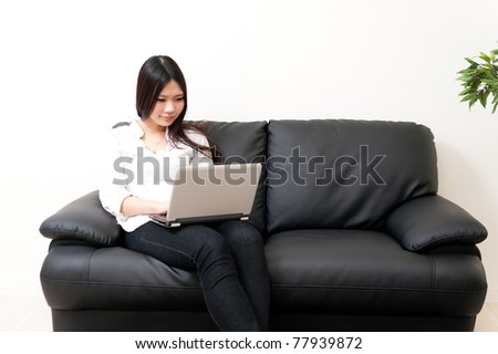 beautiful asian woman relaxing on the couch