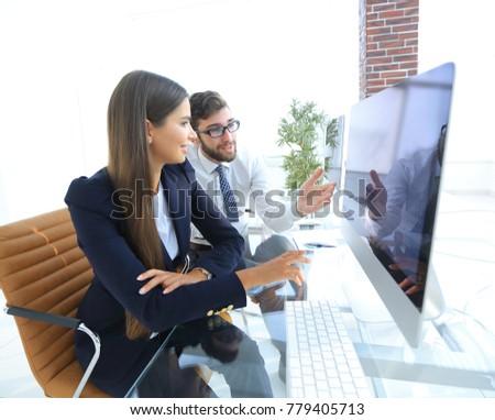 business woman with a colleague sitting at a Desk
