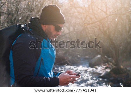 man with smartphone in nature