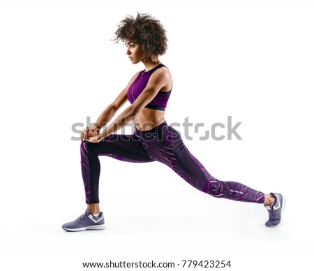 Fitness african girl doing stretching workout. Full length shot of young girl on white background. Stretching and motivation Royalty-Free Stock Photo #779423254