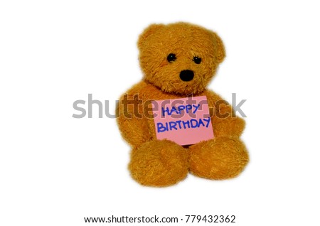 Cute brown plush teddy bear holding a pink card saying Happy Birthday. image is with an isolated white background. 