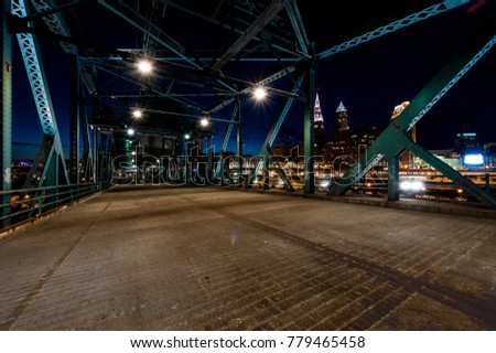 A night view of the Cleveland, Ohio skyline from the road deck of the abandoned Eagle Street lift bridge.