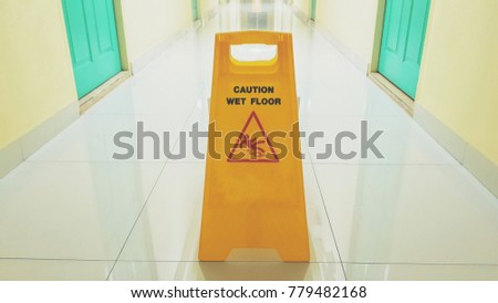 Caution wet floor sign on the floor of hotel for safety