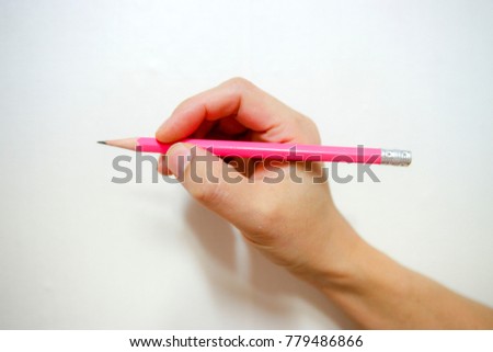 Male hand holding pink pencil with the bandaged on isolated white background
