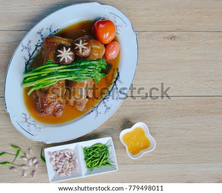 Pork on a plate of pork cooked vegetables tomato wood background Pretty fresh garlic sauce picture right foods closeup 