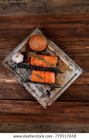 delicious portion of raw fresh salmon fillet with aromatic herbs and spices on vintage tray over wooden table - healthy food, diet cooking concept with background space