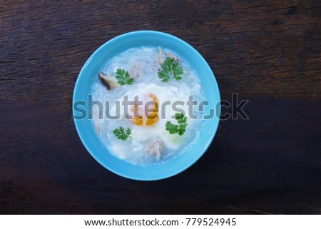  Pork Spare Ribs Rice Noodles Soup with egg on wooden table prepare for serving in the kitchen  from top view .Bowl of Egg porridge , Asian food image.