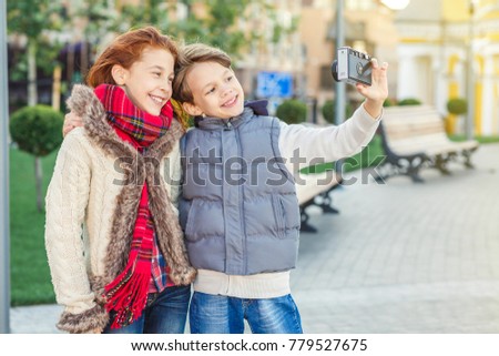 Adorable young brother and sister taking selfies together outdoors copyspace weekend holidays kids children emotions happiness recreation technology travel tourism trip family bonding siblings