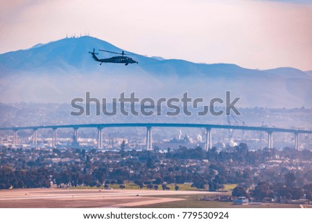 Summer in the San Diego. San Diego Skyline and Military Choppers on the Sky over Coronado Bridge