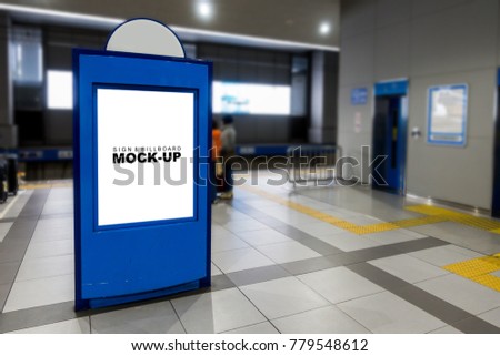Mock up with white blank screen on blue sign or billboard for advertising, information or media standing on public place near to elevator in the train station platform, with clipping path