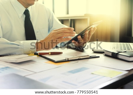 Businessman work with computer on table in office work with paper graph chart business marketing plan analysis