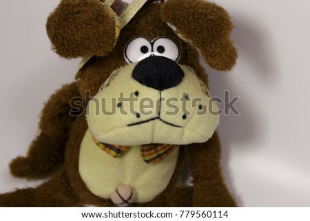 The Plush Dog in the Straw Hat. Symbol of the New Year. Stuffed Toy on a White Background.