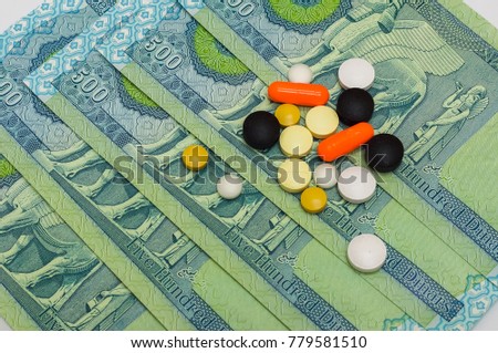 medication on uncirculated iraqi dinar (IQD) isolated on white