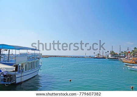 The tourist boat is painted at the pier on the Mediterranean coast in Spain.
                               