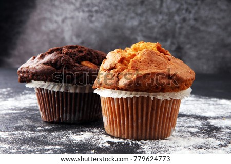 Chocolate muffin and nut muffin, homemade bakery on dark background Royalty-Free Stock Photo #779624773