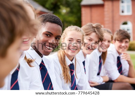 Group Of Teenage Students In Uniform Outside School Buildings Royalty-Free Stock Photo #779645428