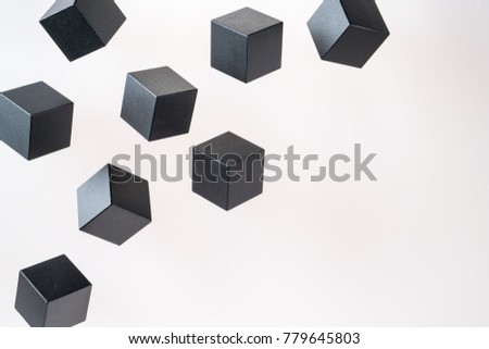Black wooden cube shapes are floating. Concept of creative, logical thinking. Abstract geometric real floating wooden cube.
