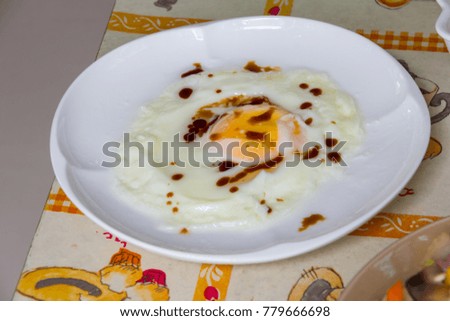 Fried egg on white dish