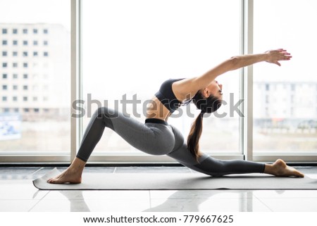 Young beautiful woman practicing yoga with mountain view in the background. Freedom concept. Calmness and relax, woman happiness. Toned picture